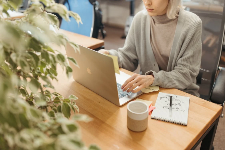 Woman using a laptop to research website traffic tools and safelist mailers