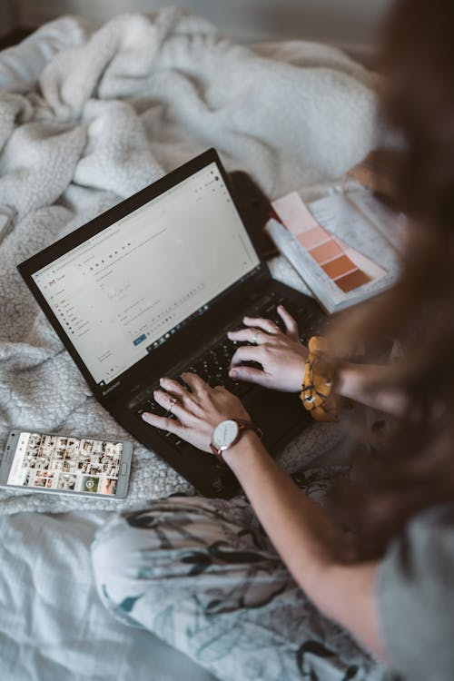 Person typing an email on a laptop for a digital marketing campaign