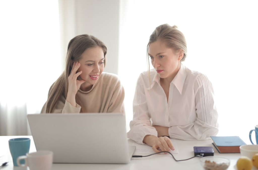 Women working on laptop exploring free traffic tools to avoid high PPC costs