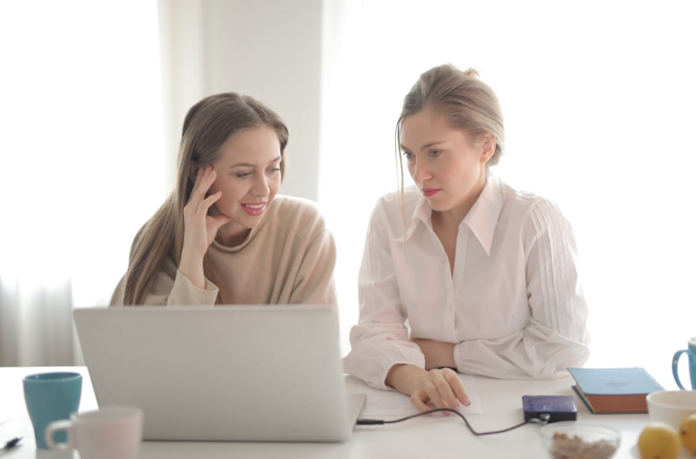 Women working on laptop exploring free traffic tools to avoid high PPC costs